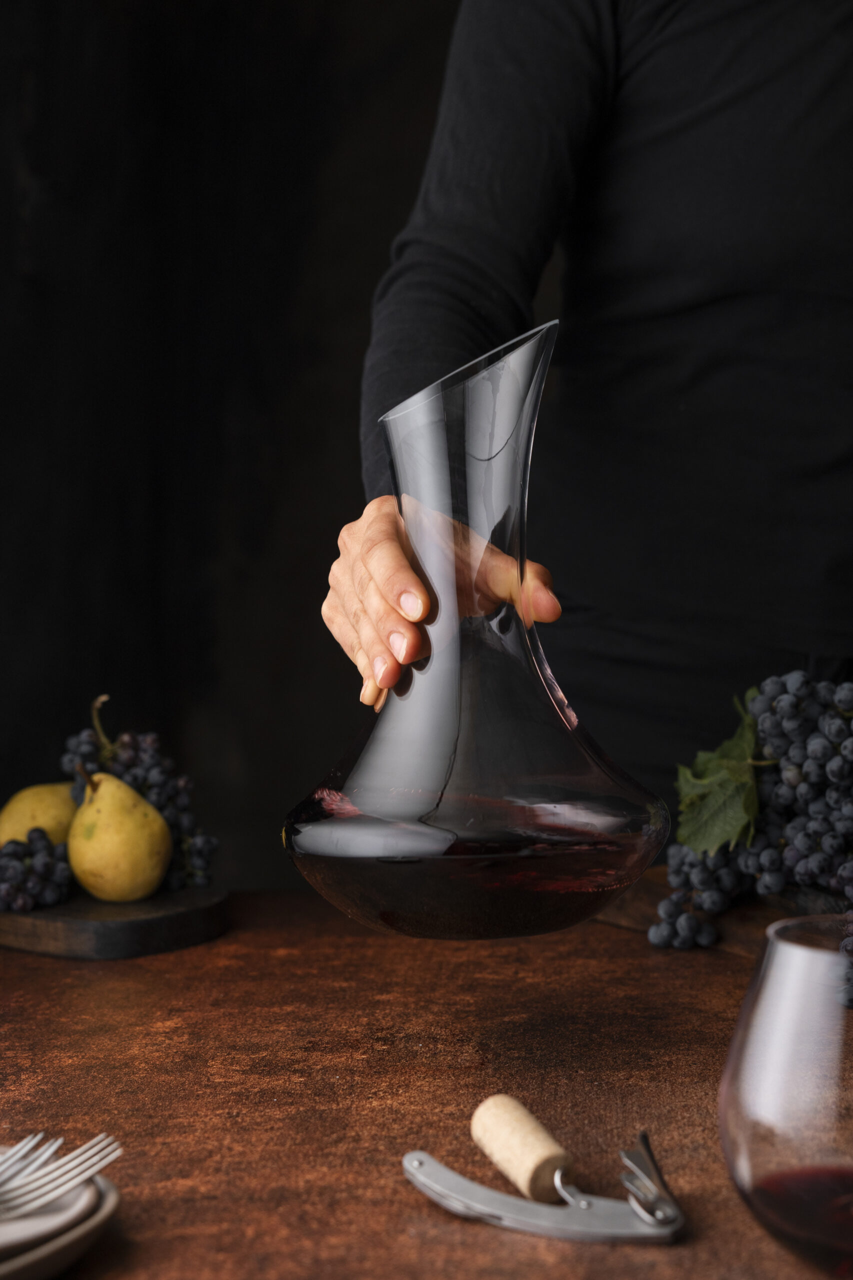 front-view-hand-holding-decanter